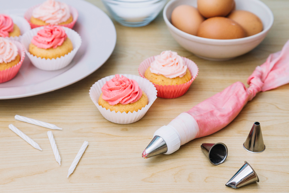 cotton-icing-bag-with-nozzle-cupcake-eggs-candles-wooden-desk